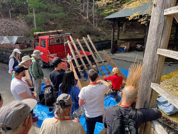 Haruo Nishio demonstrating traditional thatching at a kominka cultural event in Japan