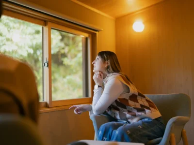 Guest looking out from the bedroom of Obatake thatched house in Miyama Kyoto