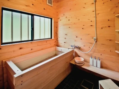hinoki cypress bath in modern thatched roof villa Miyama Kyoto