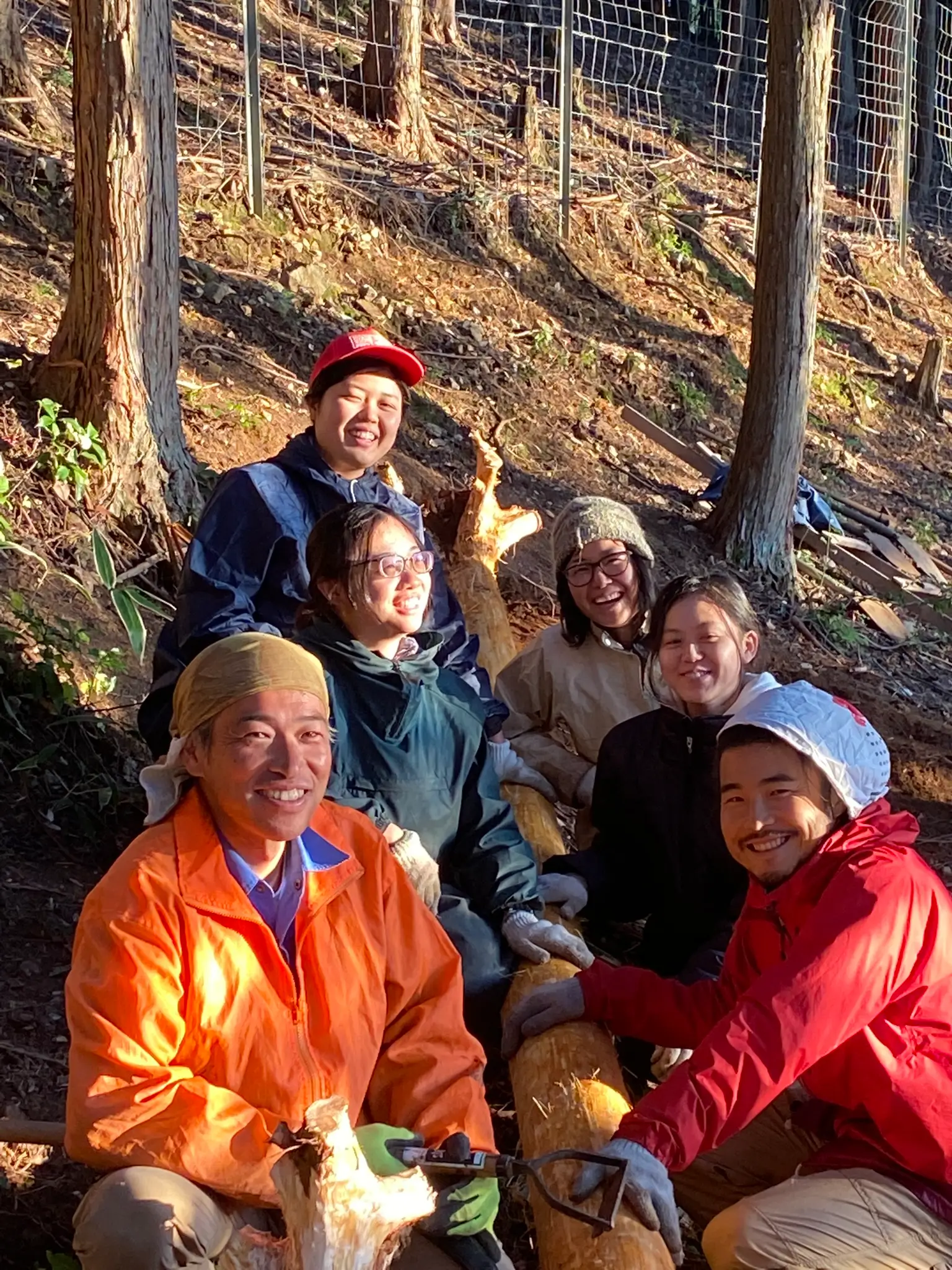 Haruo Nishio working with young people preparing yukiwari thatch for a Japanese roof