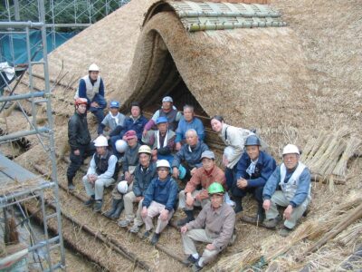 Haruo Nishio working at a Japanese cultural property thatched roof site
