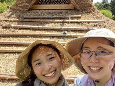 Young workers at a traditional thatched roof work site in Japan