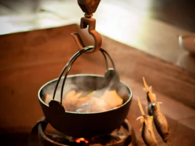 Cooking hot pot and fish at a traditional irori hearth in Miyama Kyoto