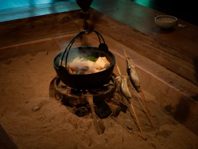 Irori hot pot and grilled fish cooking in a thatched house in Miyama Kyoto