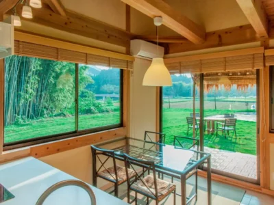 dining space with countryside view in modern thatched villa Miyama Kyoto