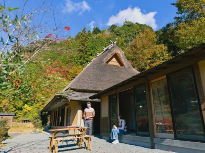 Guests having a barbecue outside Obatake thatched house in Miyama Kyoto