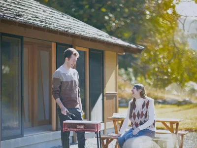 Guests enjoying a barbecue in front of Obatake thatched house Miyama Kyoto