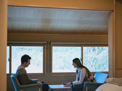 Guest relaxing in the bedroom of Obatake thatched house Miyama Kyoto