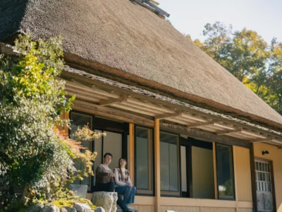 Guest relaxing on the engawa veranda of Obatake thatched house Miyama Kyoto