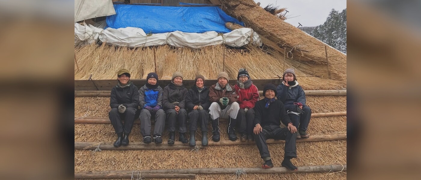 Young volunteers helping with traditional Japanese thatching work