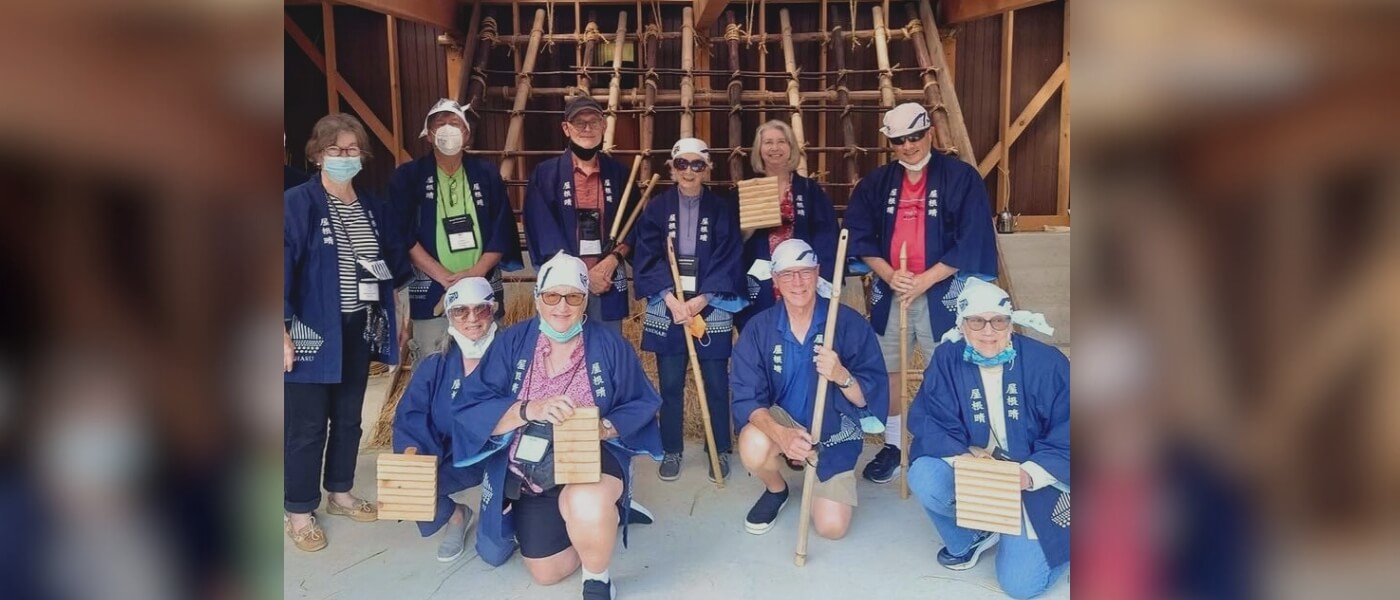 Visitors learning traditional Japanese thatching in a hands-on roof thatching experience