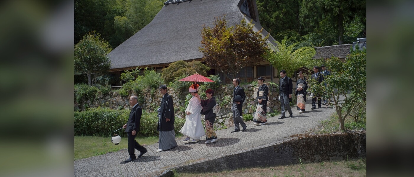 Traditional Japanese wedding ceremony in a thatched-roof house