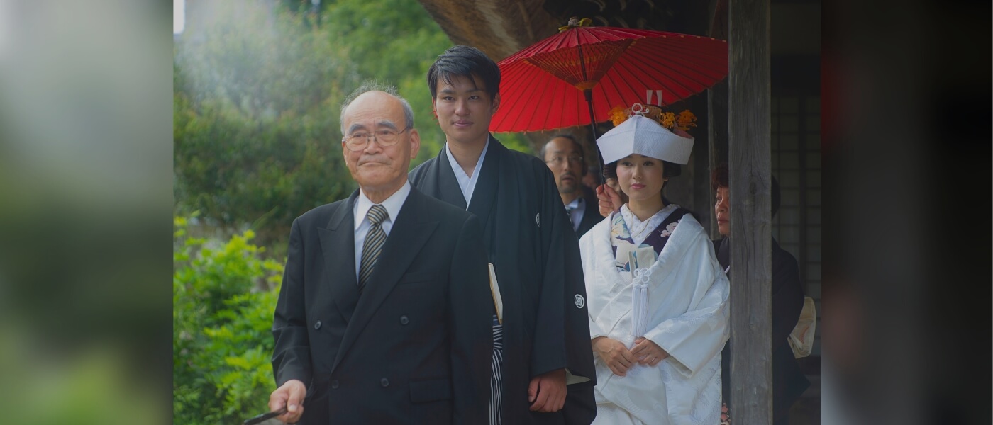 Traditional Japanese wedding ceremony in a thatched-roof house